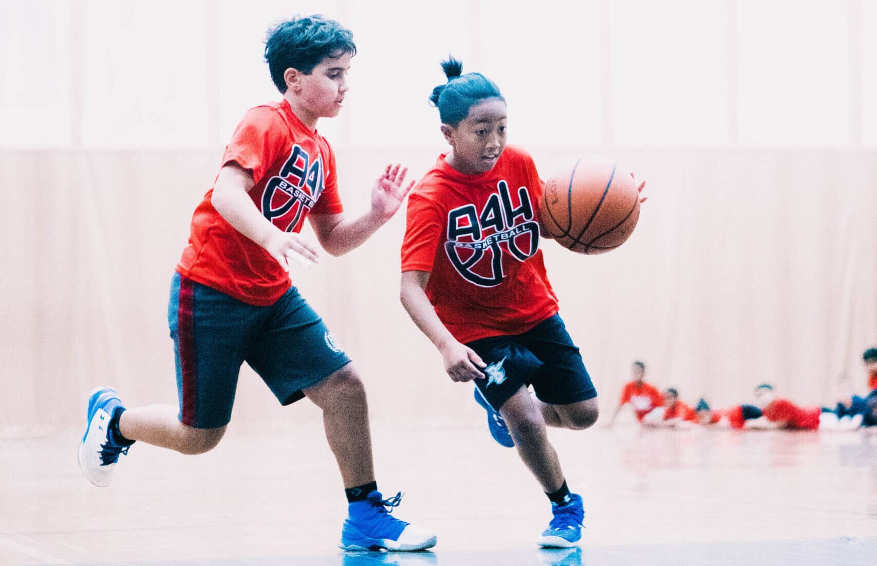 Two boys playing basketball at the A4H Sports camp