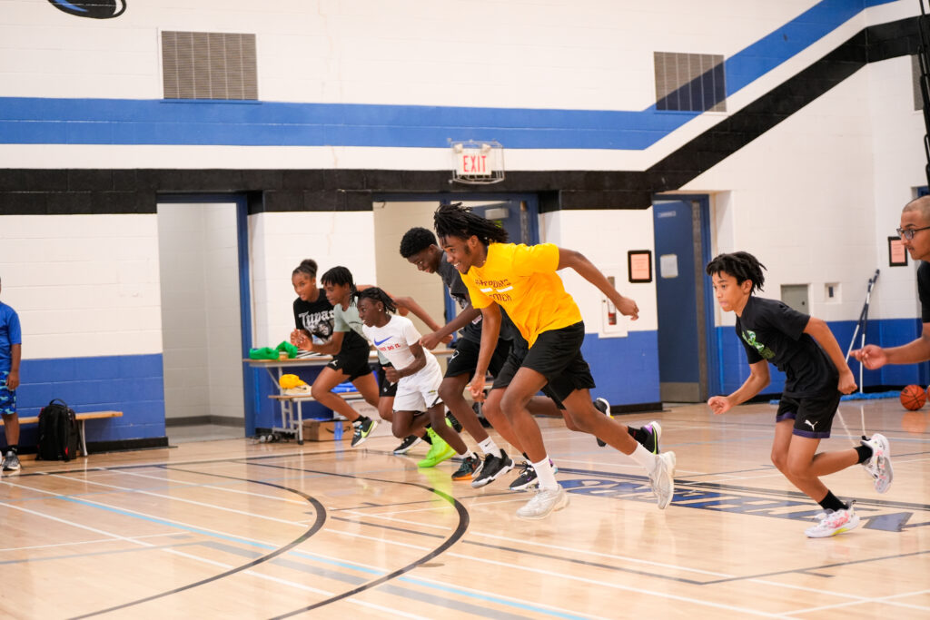 Our A4H Sports Junior Campers racing their coach in the gym