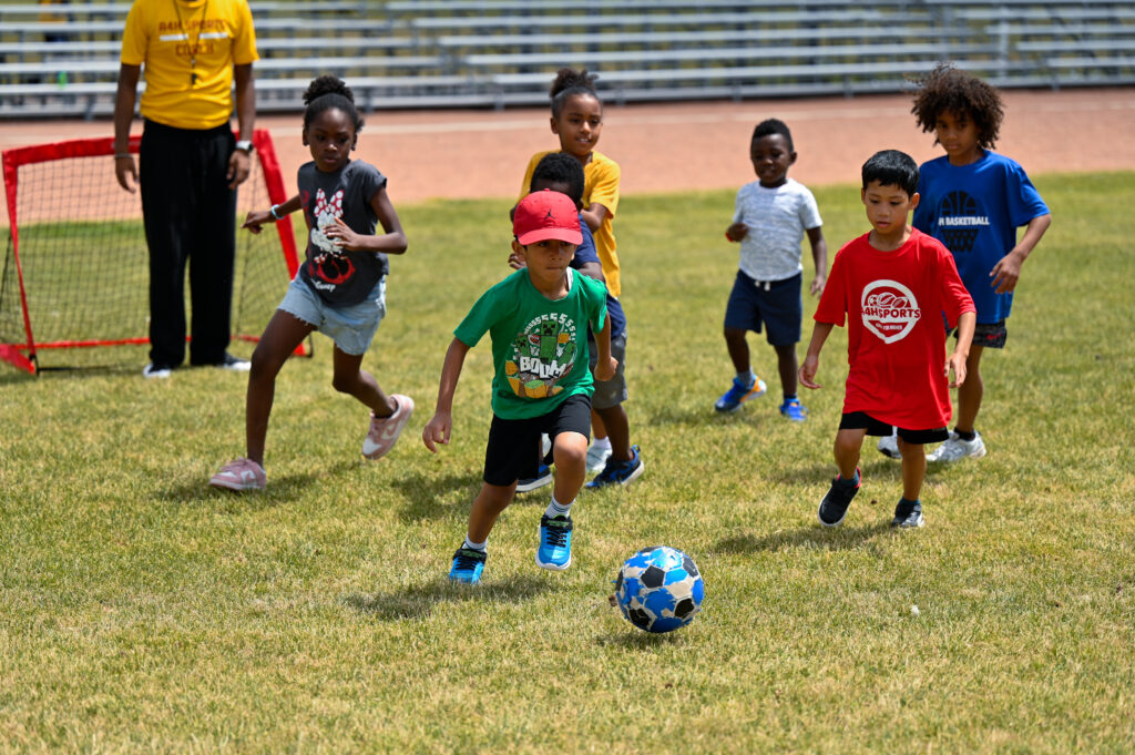 Our A4H Sports Youth Campers playing soccer on the field