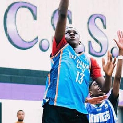 black child shooting basketball