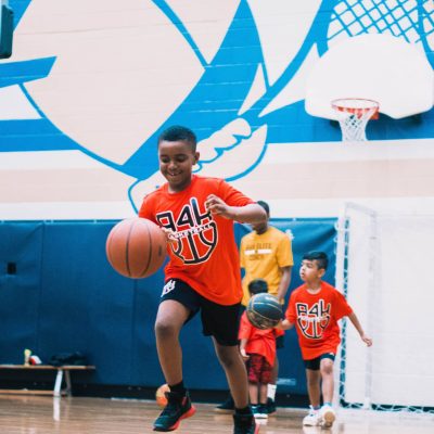 black boy bouncing basketball